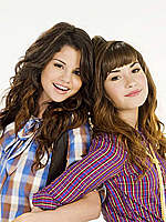 Demi Lovato posing for mags with Selena Gomes
