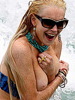 Lindsay Lohan boob out on the beach shots
