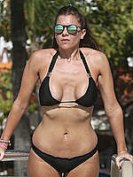 Imogen Thomas in black bikini on the beach