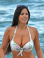 Claudia Romani cleavage in bikini on a beach