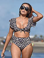 Laura Simpson in leopard bikini on a beach