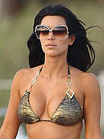 Kim Kardashian cleavage in bikini on a beach