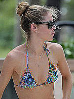 Doutzen Kroes wearing a sexy bikini at a pool